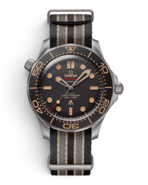 OM33 Omega Diver 300M 007: esfera oscura con brillos beige, bisel marrón numerado y correa rayada negra y gris